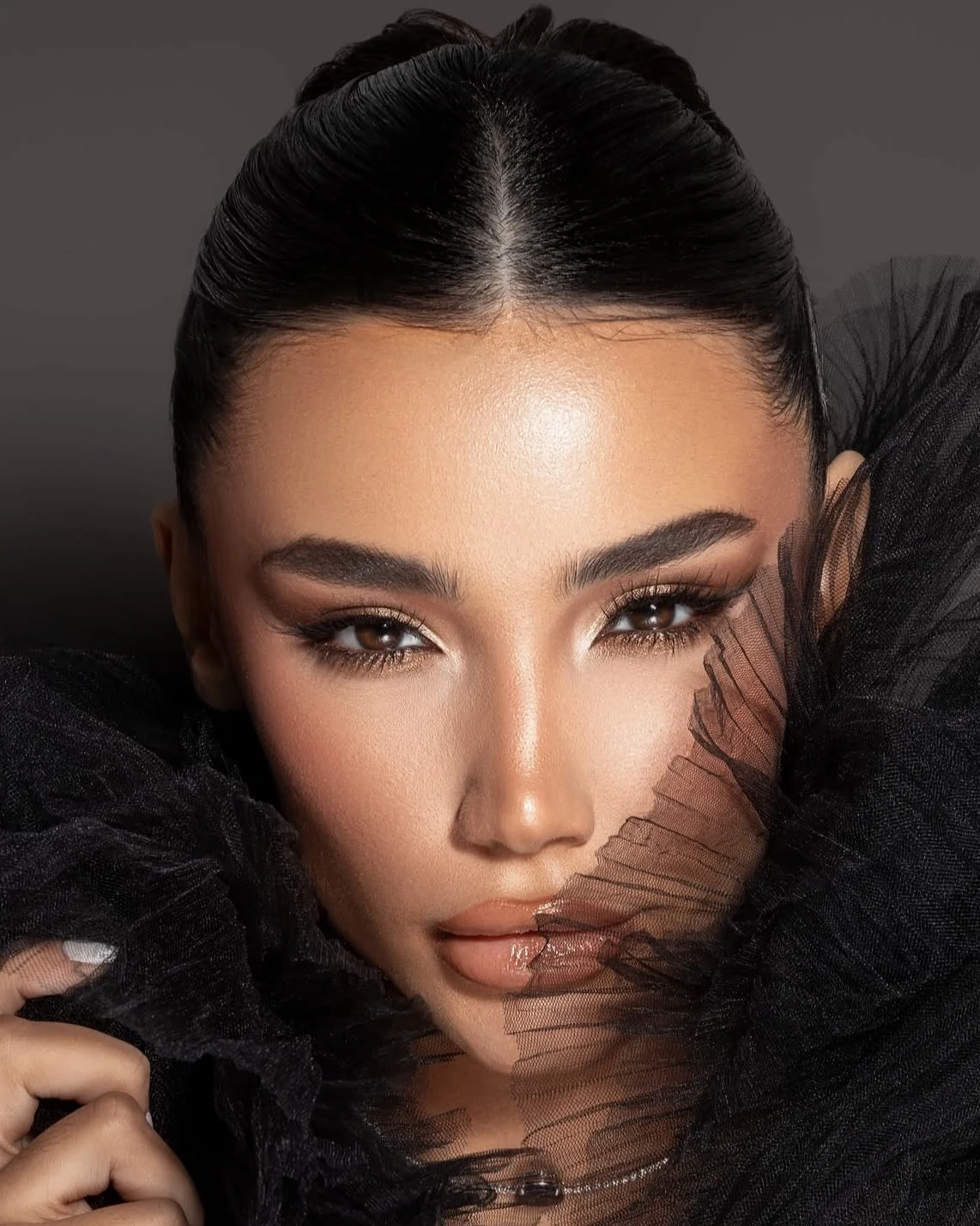 Smoky definition framed by black tulle.