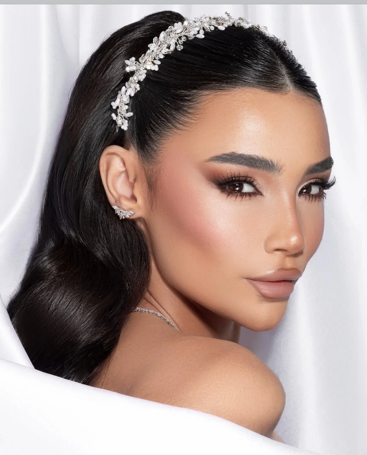 Bridal makeup by Hawraa Dergham with a crystal headband