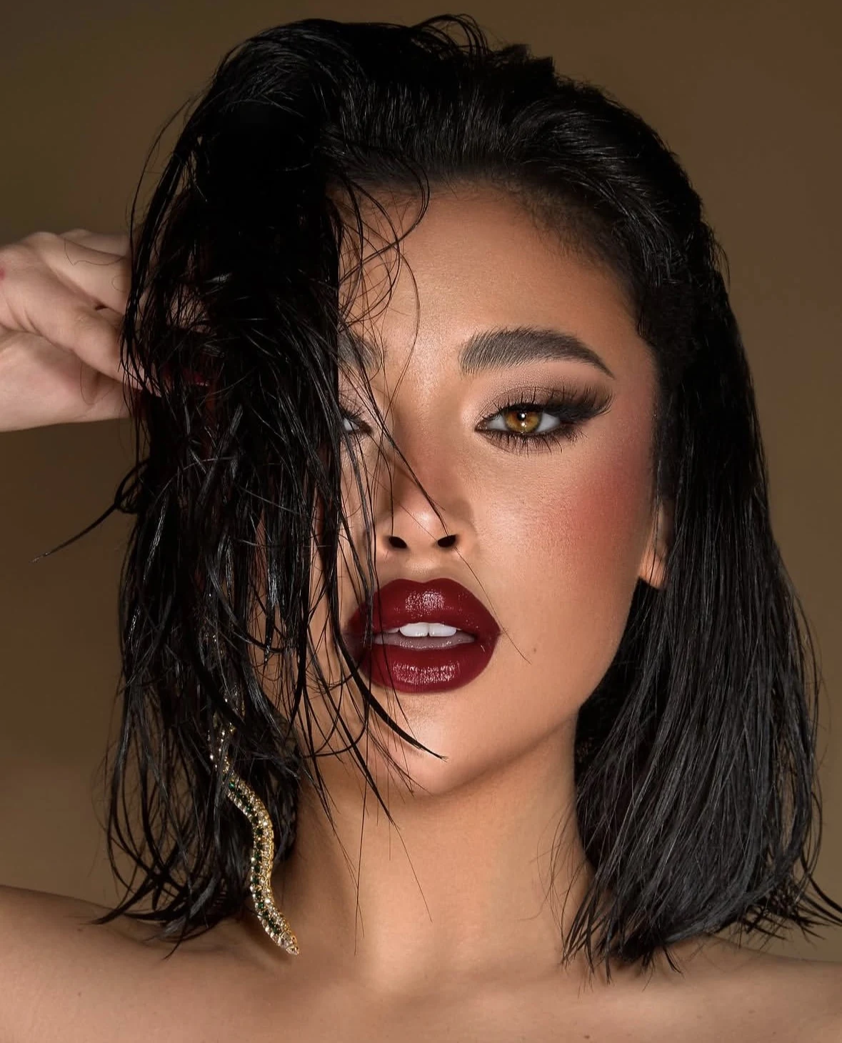 Glossy cherry lips and a bold, modern eye.