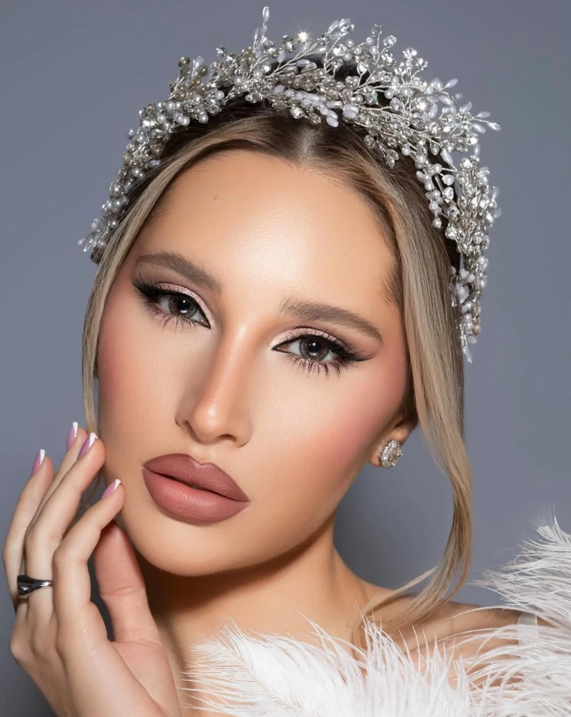 Soft bridal tones and a matte rose lip with a crystal crown.