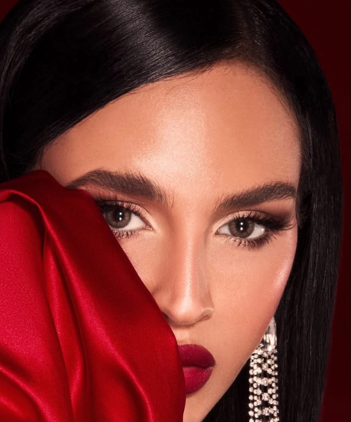 A deep red lip, sculpted eyes and dramatic red satin.