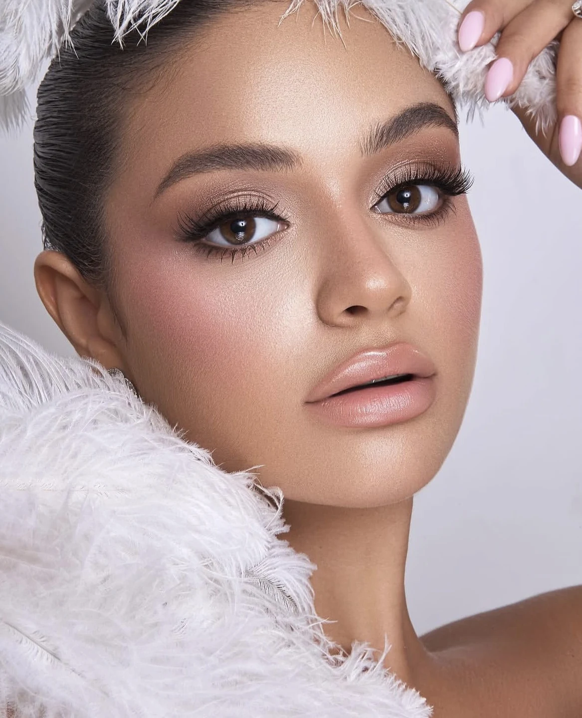 A soft shimmer, warm blush and a glossy nude lip.