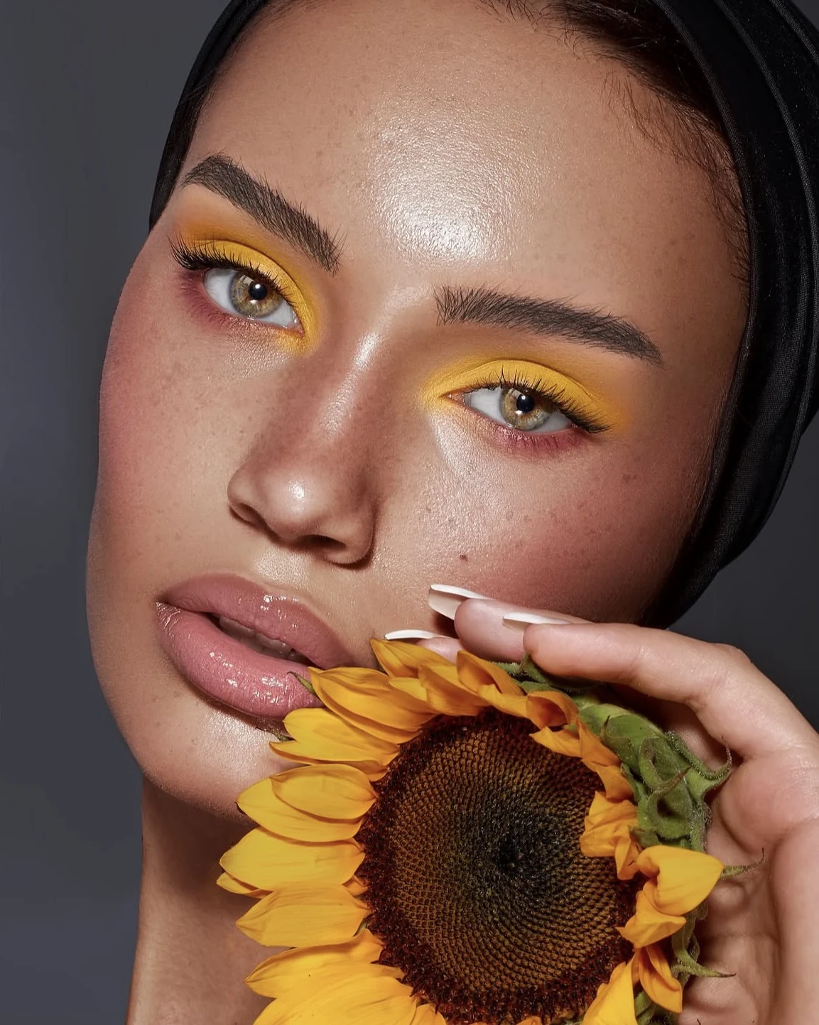 Sunflower yellow eyes with fresh skin and glossy lips.